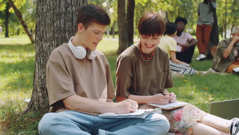College-Groupmates-Studying-Outdoors-in-Park